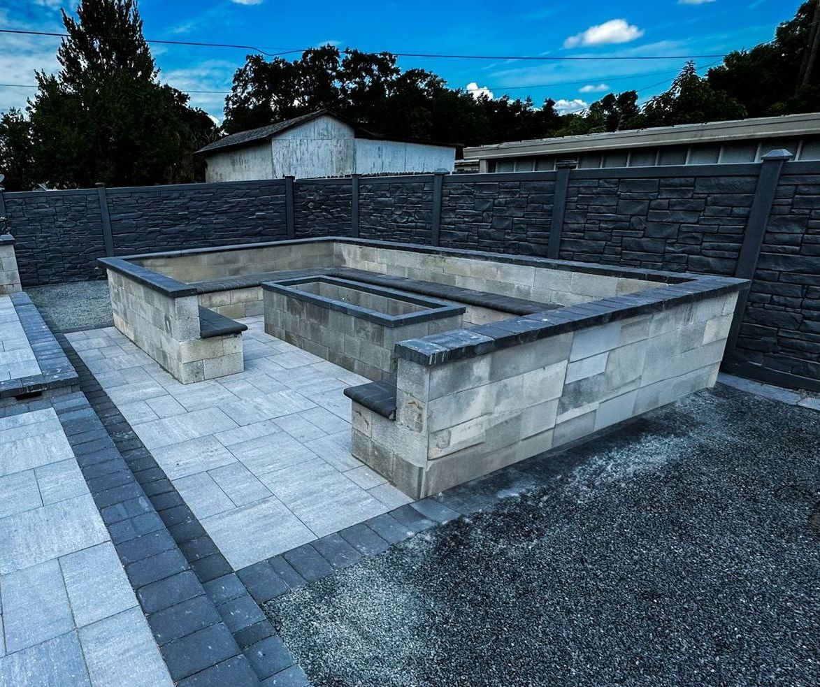 there is a fire pit in the middle of the patio .