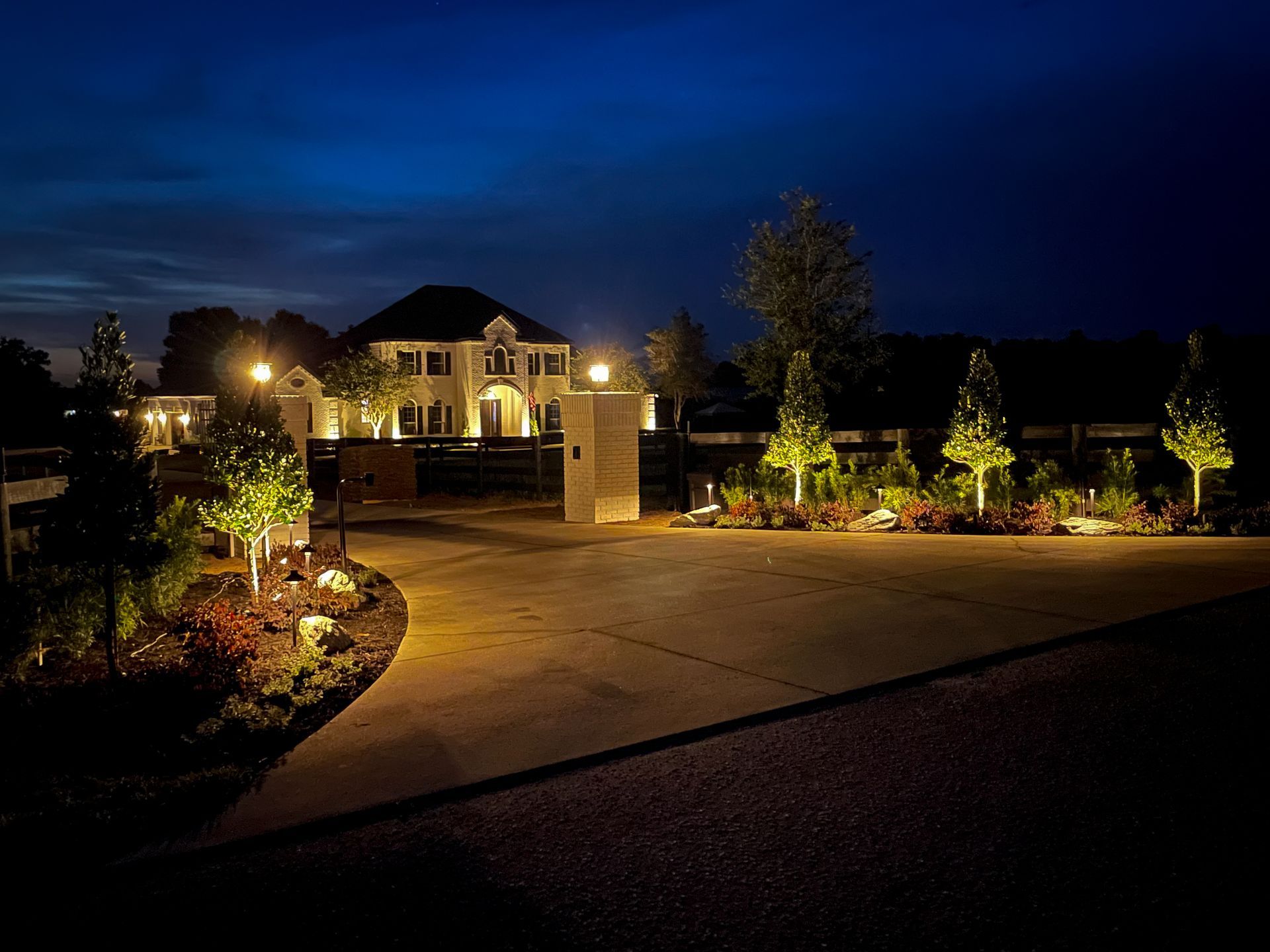 a driveway with a lot of lights on it at night .