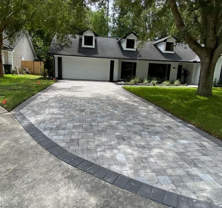 a potted plant is sitting on top of a set of steps on a patio .