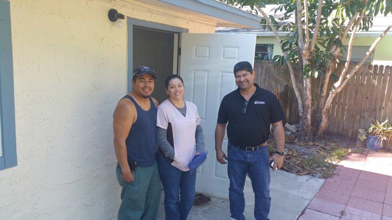 Male House Agent Showing New House to Couple — Cape Coral, FL — Ordonez Realty