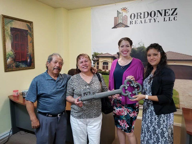 Staff Issuing Big House Key to Old Couple — Cape Coral, FL — Ordonez Realty