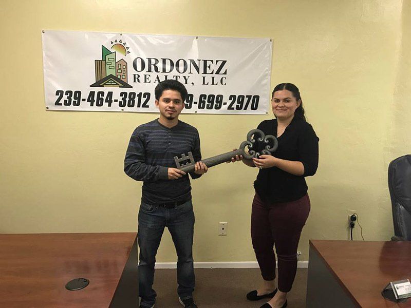 Staff Issuing Big House Key to Buyer — Cape Coral, FL — Ordonez Realty