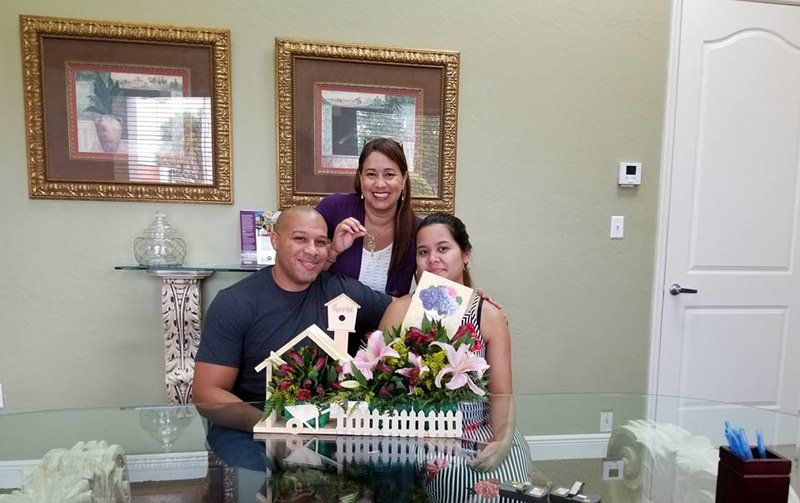 Couple in Front of House Model — Cape Coral, FL — Ordonez Realty