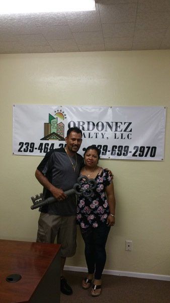 Couple Holding Big House Key — Cape Coral, FL — Ordonez Realty