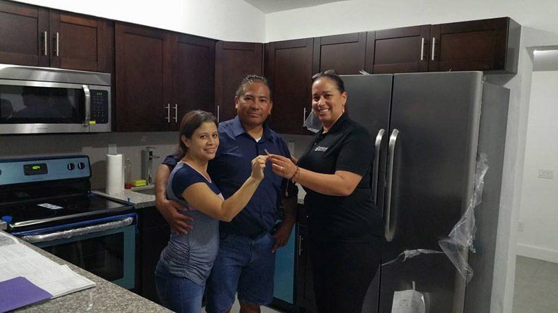Female House Agent Showing New House to Couple — Cape Coral, FL — Ordonez Realty
