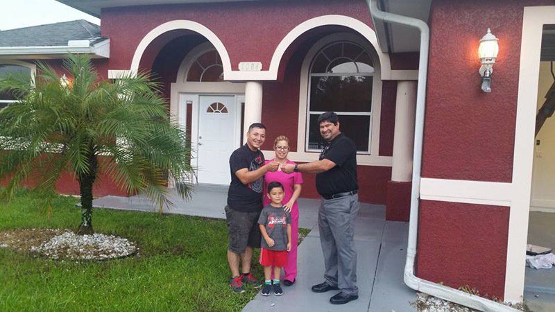 Family Outside Their New Home — Cape Coral, FL — Ordonez Realty
