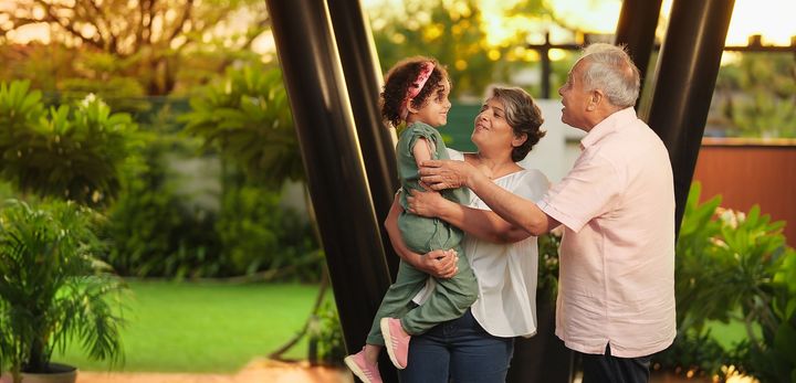 Grandparents holding a child