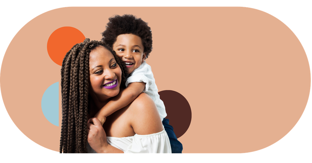 A woman is carrying a child on her back.
