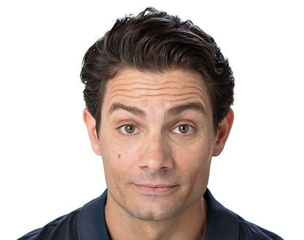 Man with brown hair, smiling slightly, against a white background.