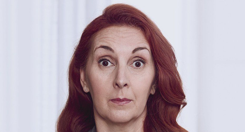 Woman with red hair and surprised expression.