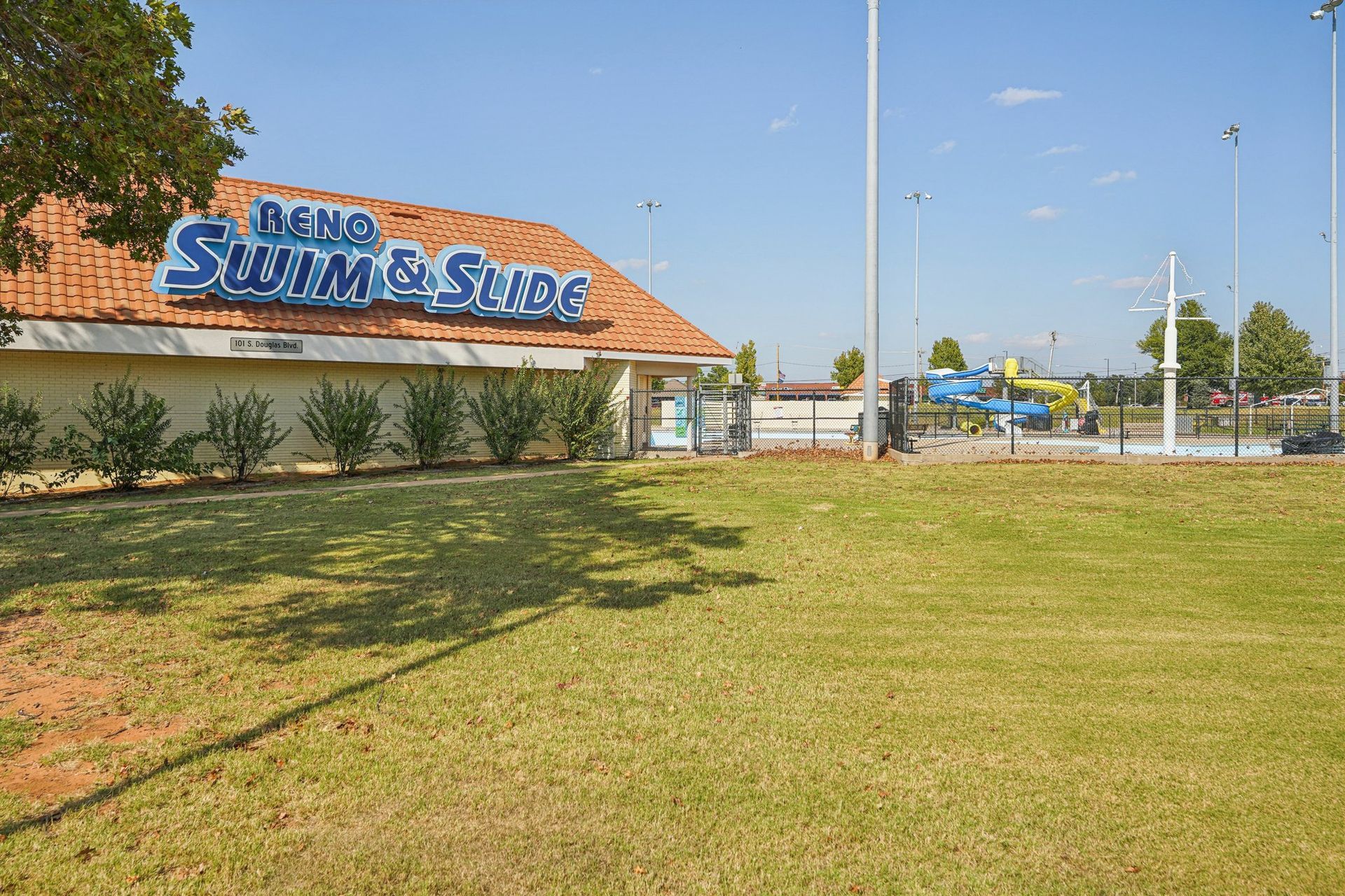 Reno Swim & Slide building with a pool and water slides on a sunny day.