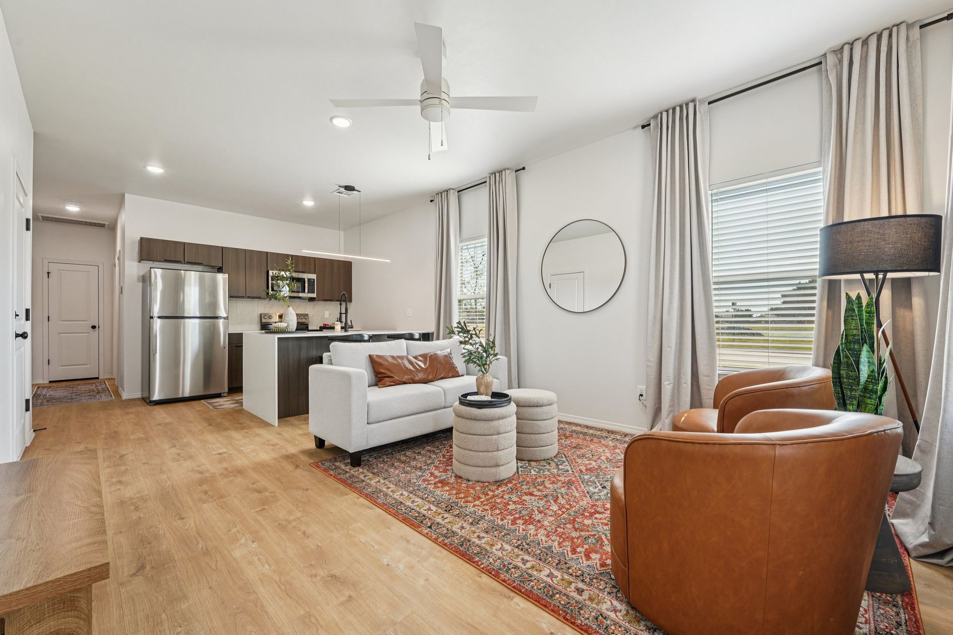 Green grassy backyard enclosed by a wooden fence under a clear blue sky.