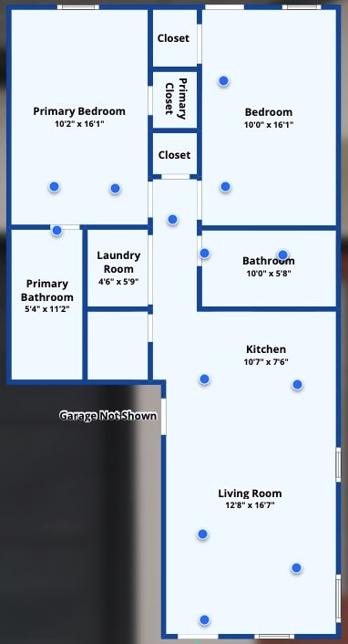 Floor plan of a two-bedroom apartment with living area, kitchen, and attached garage; red car is in the garage.