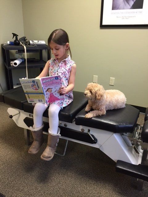 ginger reading with a child patient
