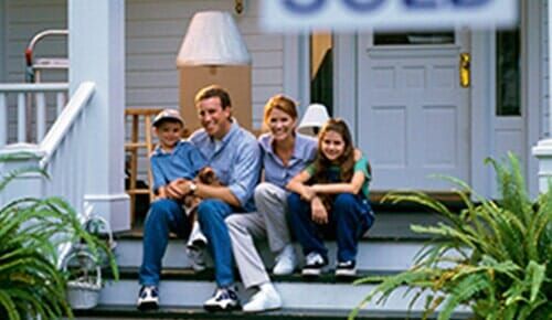 Happy Family in Front of Their House - Home Insurance in Siley City, NC