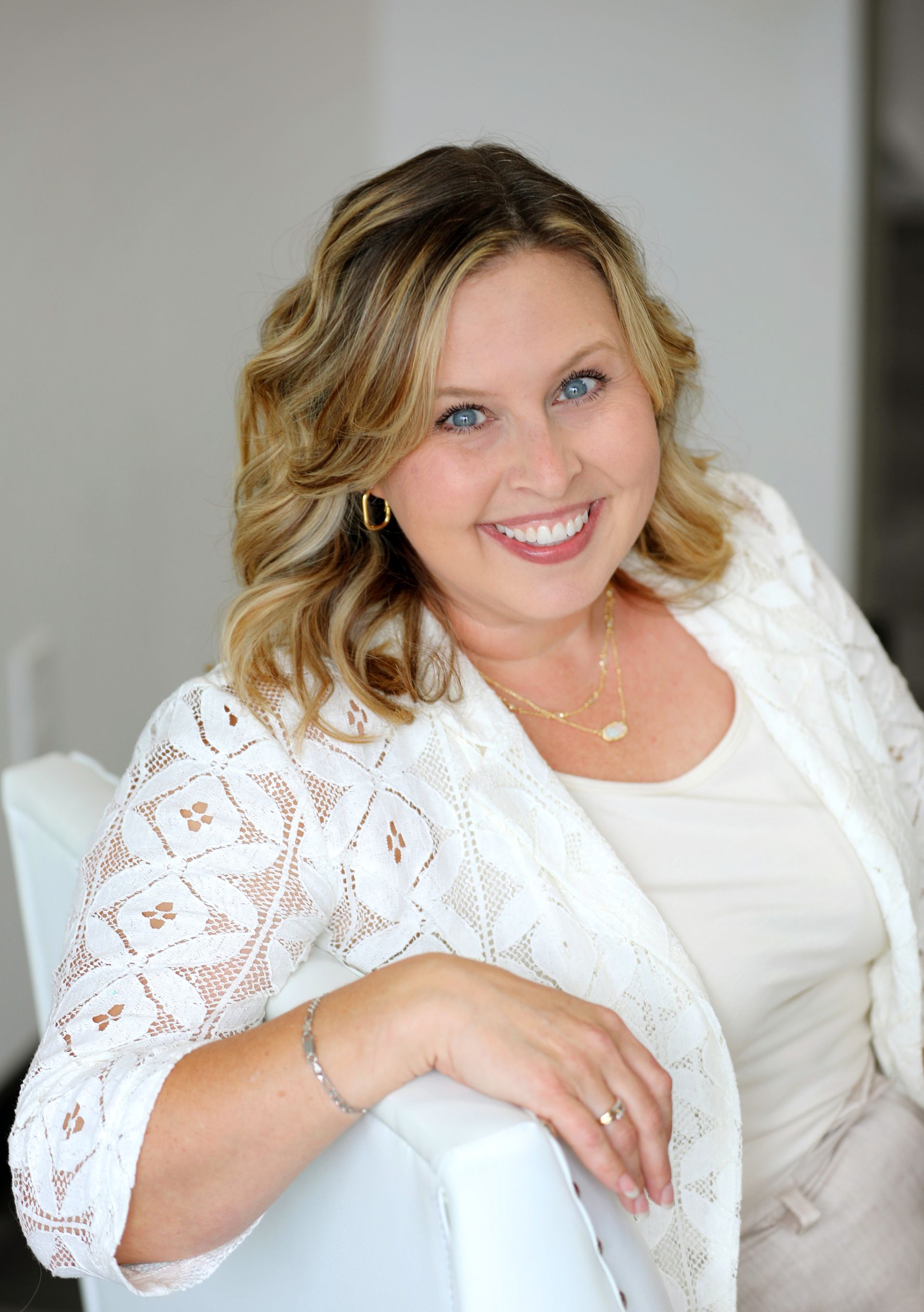 A man and a woman are posing for a picture with two dogs in front of a christmas tree.