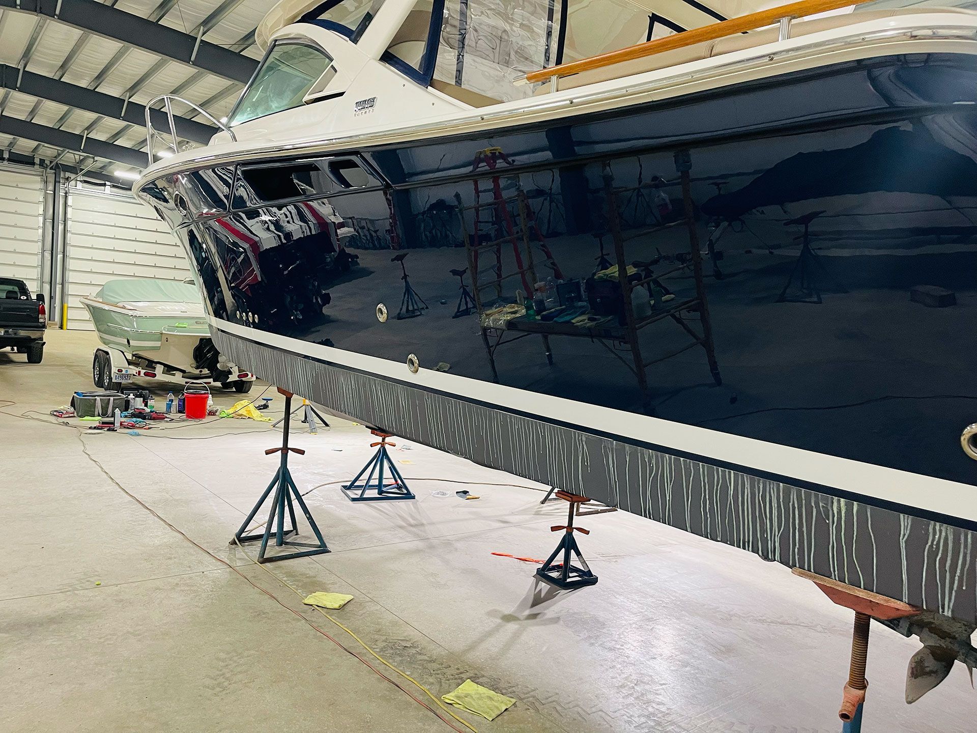 a luxury boat up on jack stands in the process of being detailed