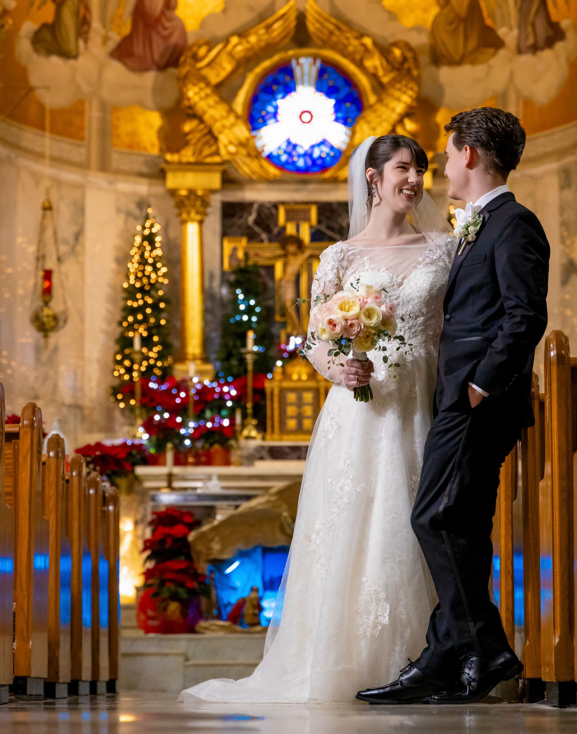 Bride and Groom posing looking at each after their church wedding ceremony 