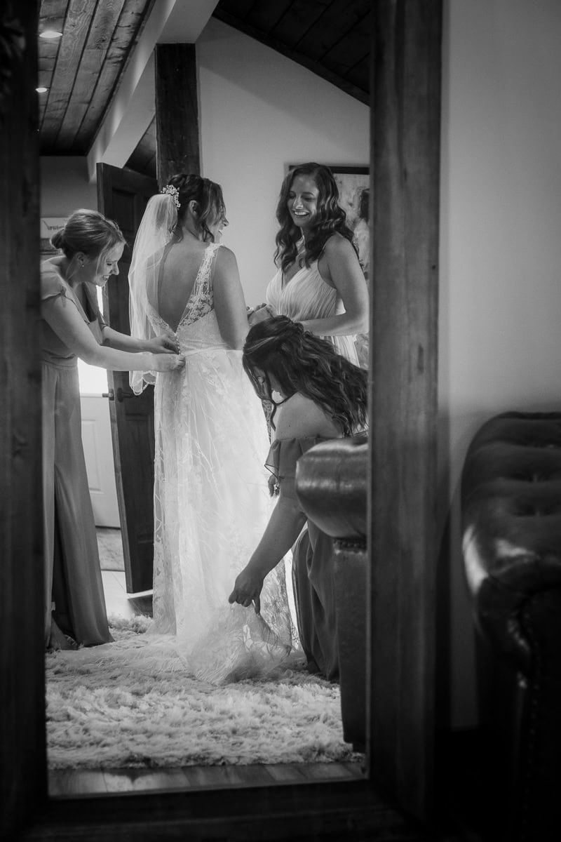 A black and white photo of a bride getting ready for her wedding.