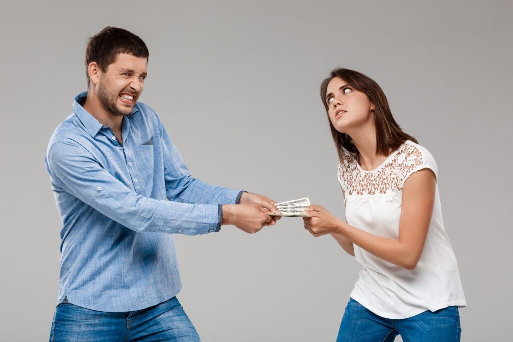 A man and a woman are fighting over money.