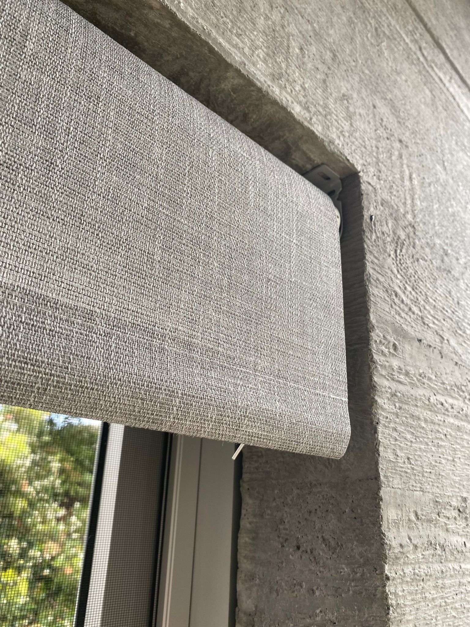 Close-up of a Textured Gray Window Awning Over a Concrete Wall — Curtain Concepts in Dunbible, NSW