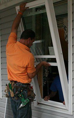 Man Installing Window — Concord, NC — B.W. Larrimore Construction