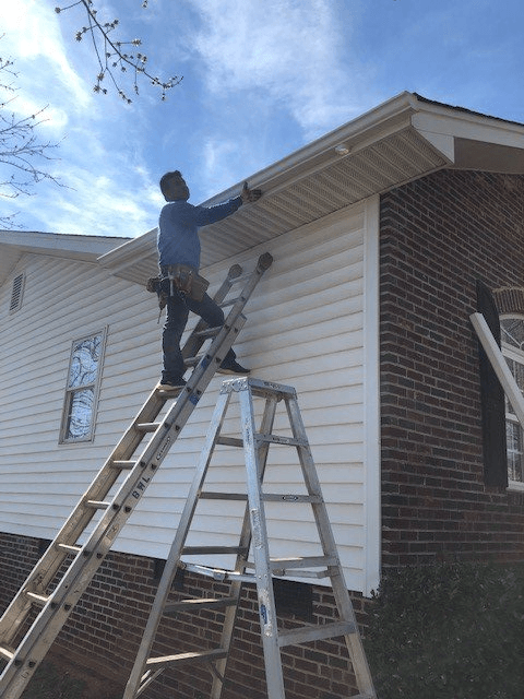 Man Cleaning The Gutter — Concord, NC — B.W. Larrimore Construction