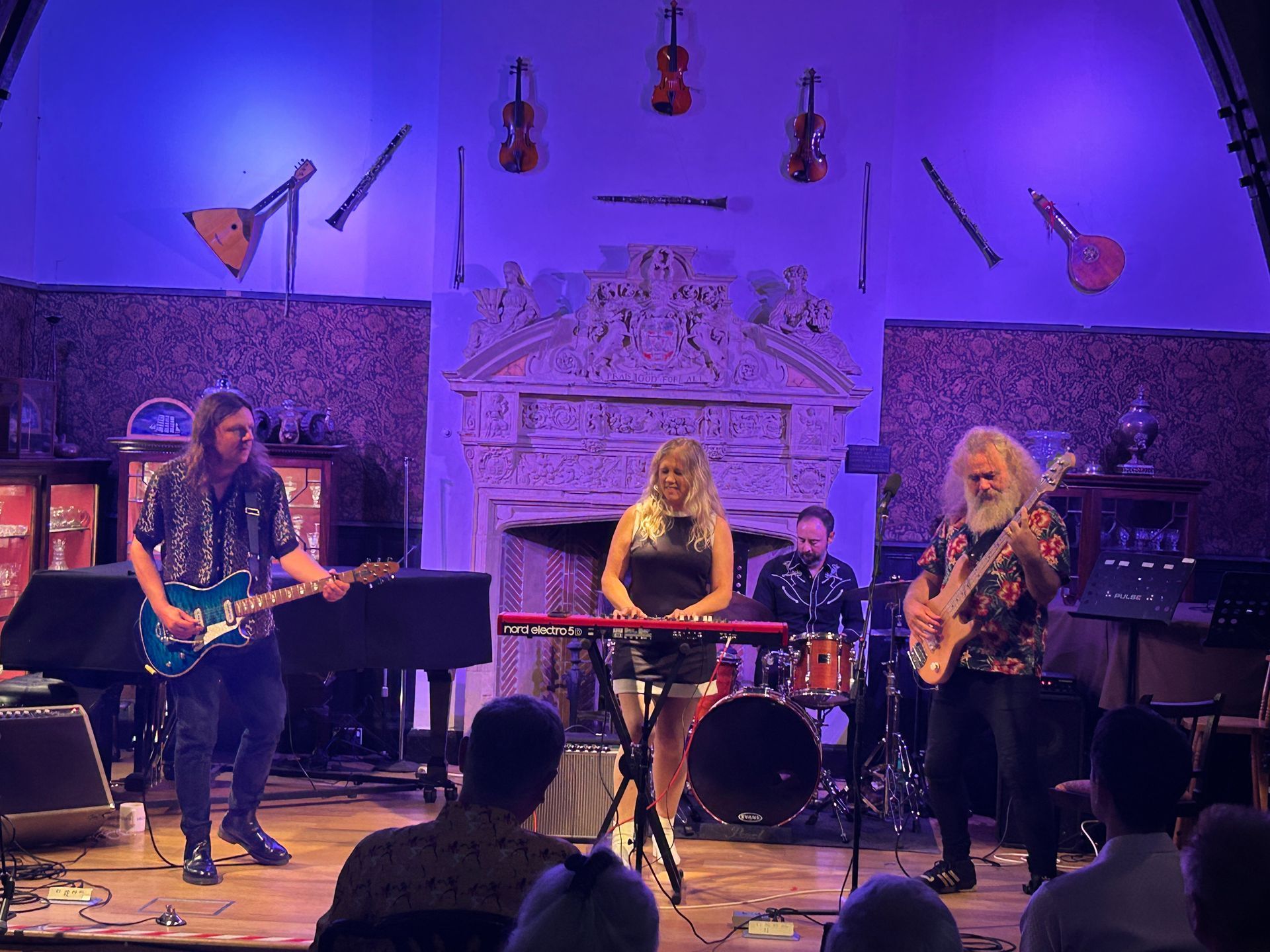 Image of Blue Feather (Entertainer) Gaz Williams on electric bass guitar and chums entertaining us with 70's rock.