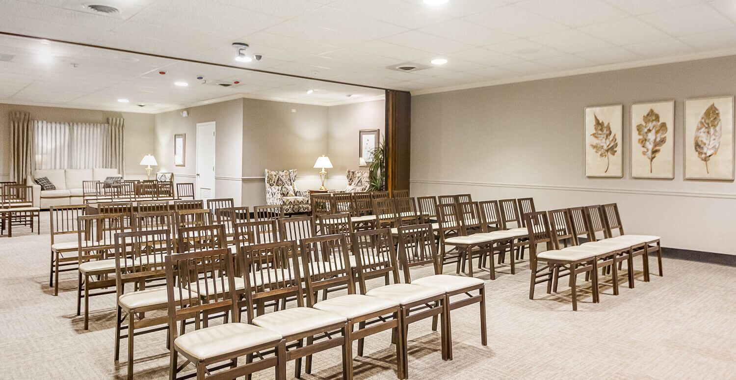 A large room filled with rows of chairs and tables.