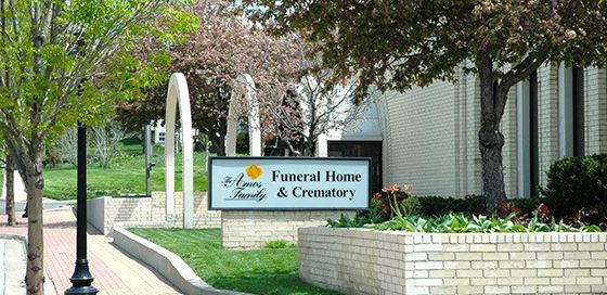 A funeral home and crematory with a sign in front of it