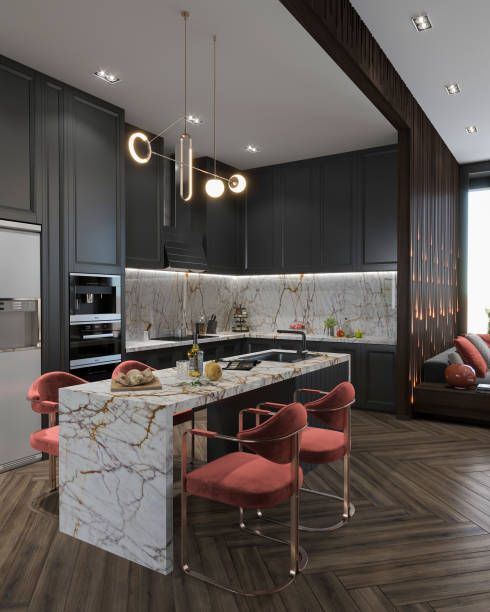 A kitchen with black cabinets and a marble counter top