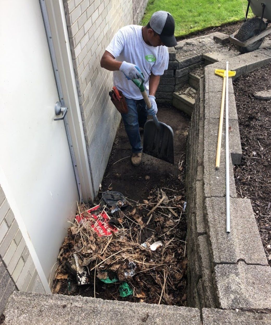 A man is digging a hole in the ground with a shovel.