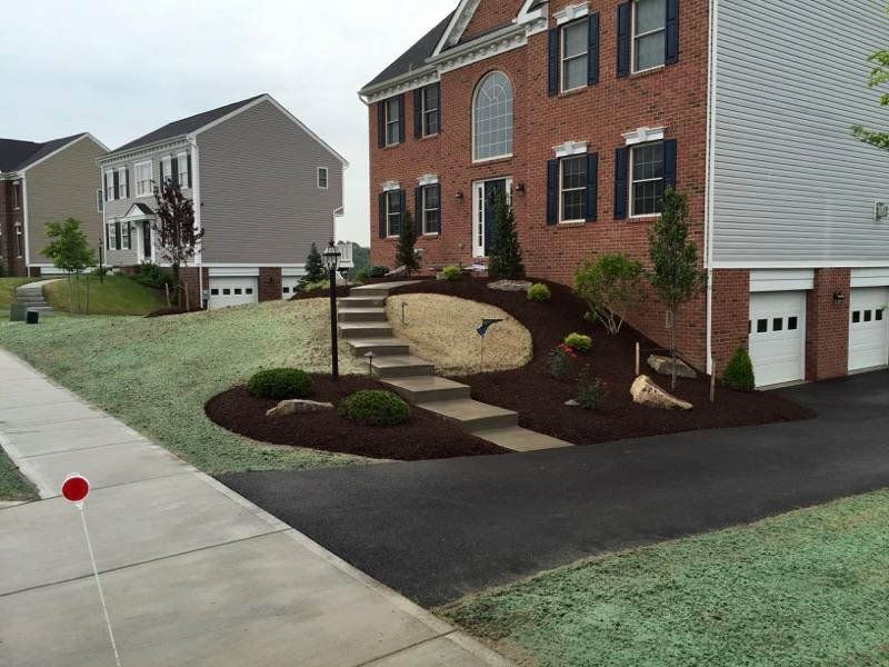 A large brick house with stairs leading up to it