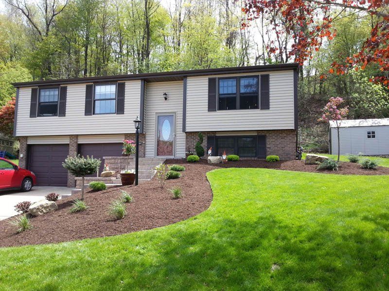A house with a red car parked in front of it