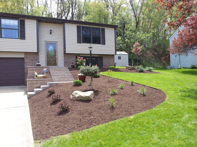 A house with a lush green lawn in front of it