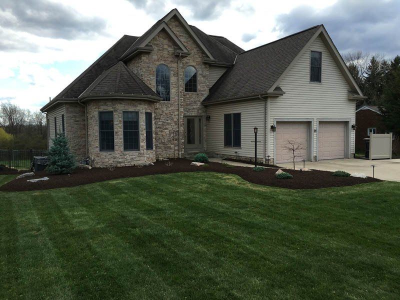 A large house with a lush green lawn in front of it