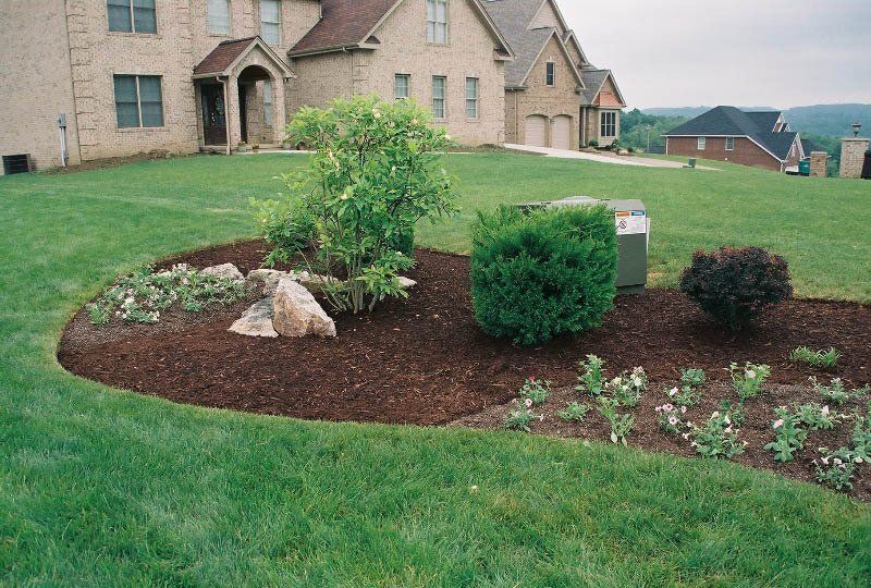 A large house with a lush green lawn in front of it