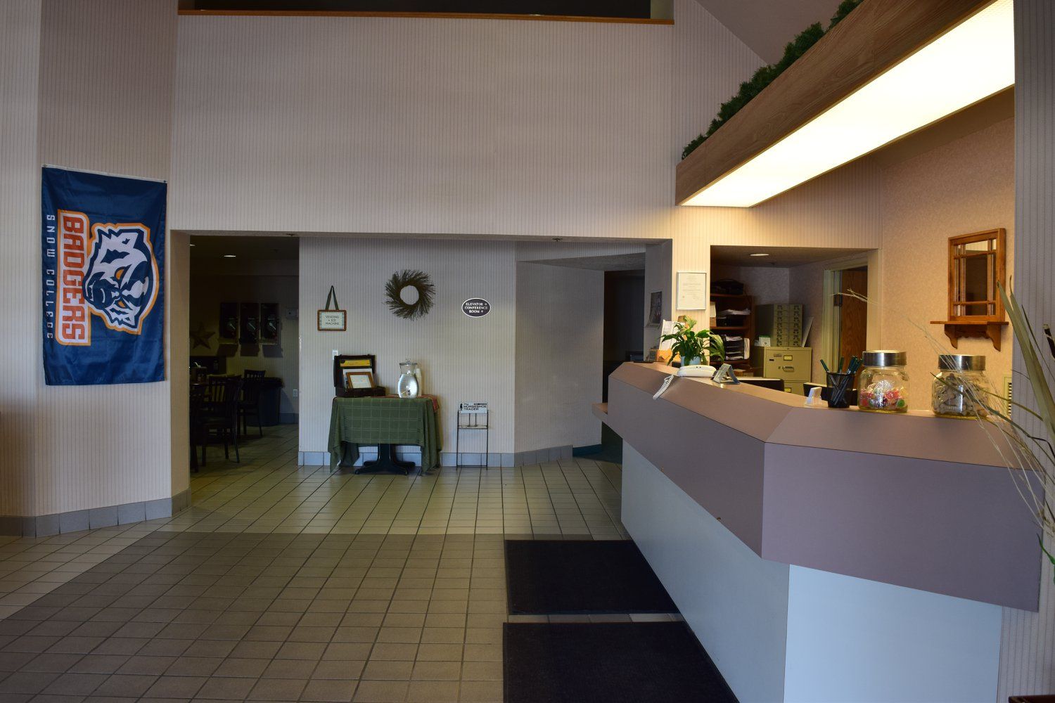 A hotel lobby with a blue banner hanging on the wall