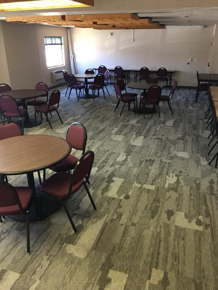 A large room with tables and chairs in it.