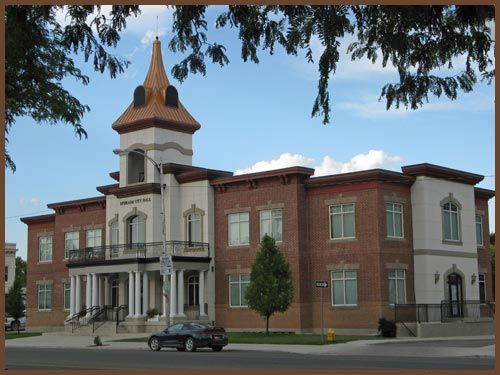 A large brick building with a car parked in front of it