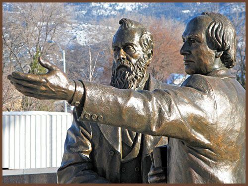 A bronze statue of two men standing next to each other