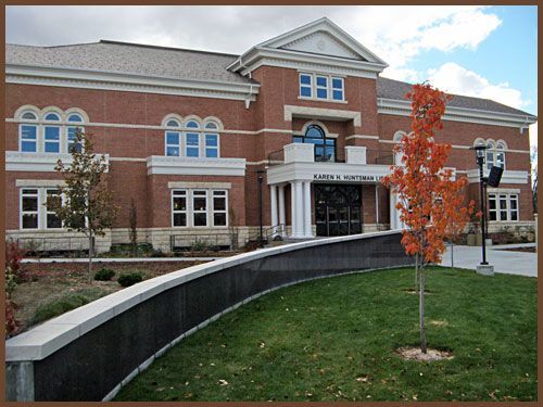A large brick building with a tree in front of it