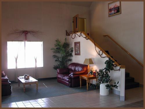A living room with a red couch and stairs