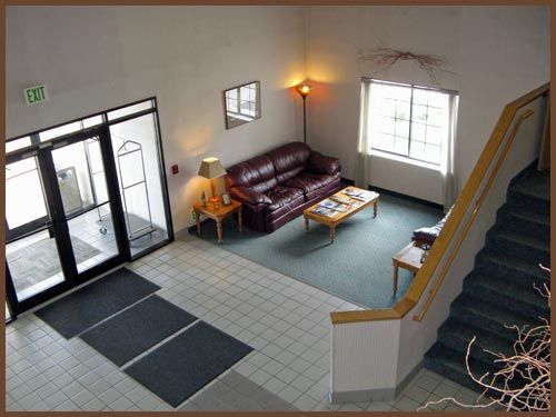 An aerial view of a living room with a couch and stairs