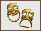 A pair of gold comedy and tragedy masks on a white background.
