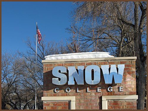 A snow college sign with a flag in the background