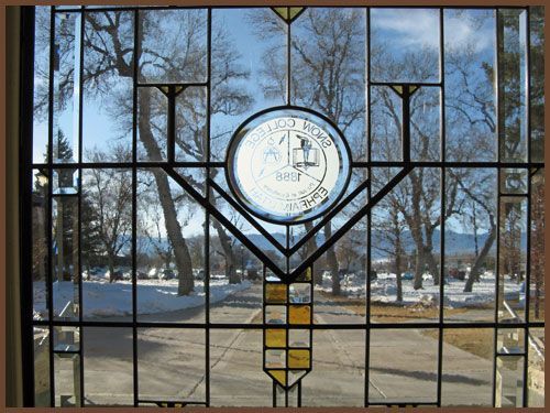 A stained glass window with a circle in the middle of it