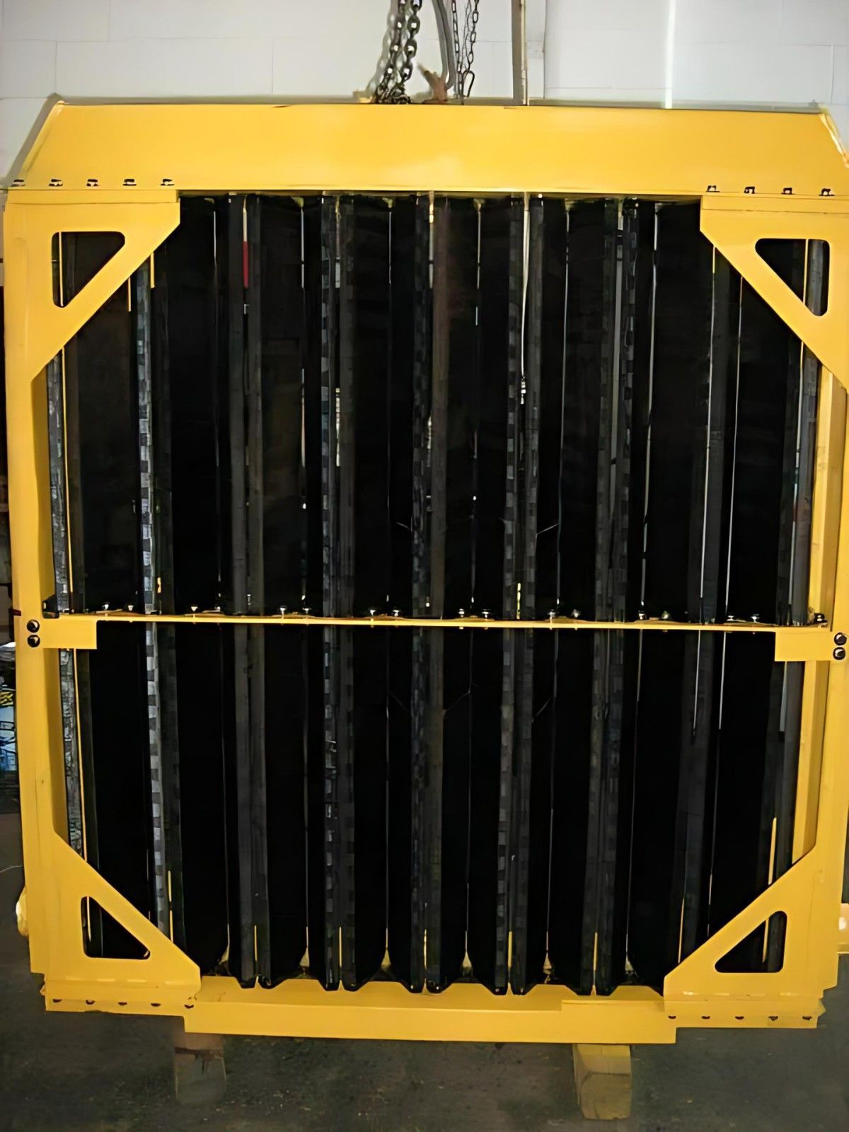A Yellow and Black Radiator is Sitting on a Wooden Pallet — Neilsen's Radiator Service in Toowoomba City, QLD
