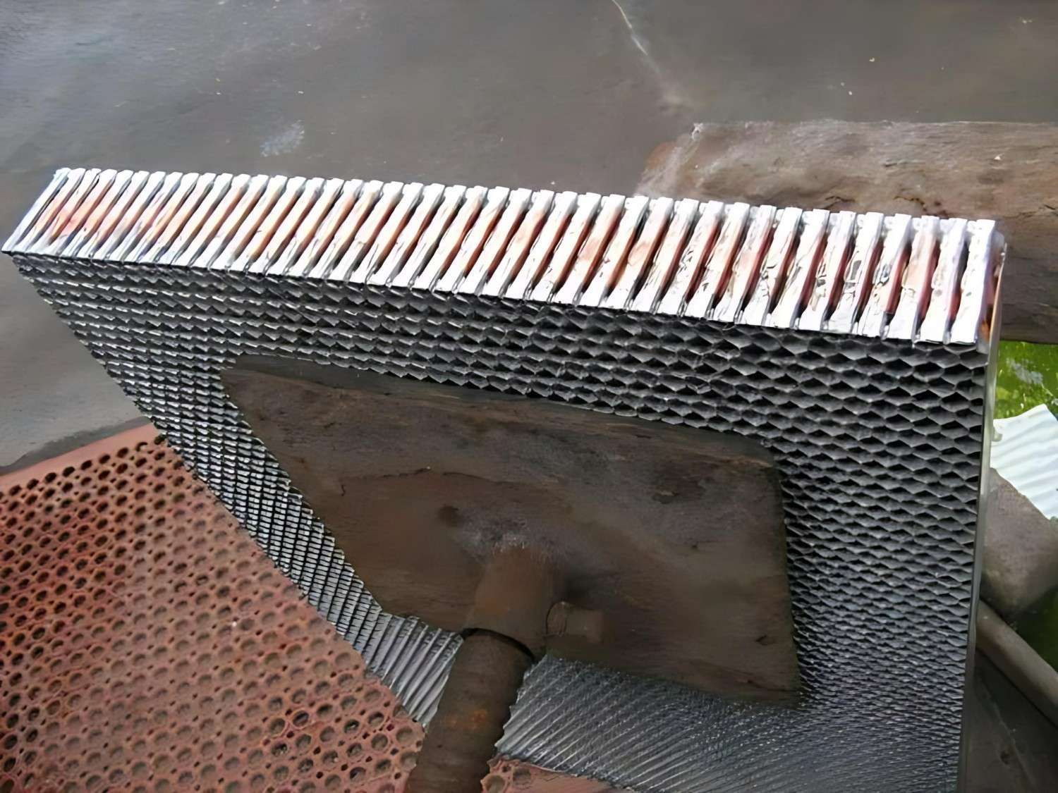 A Piece of Metal With Holes in It is Sitting on a Table — Neilsen's Radiator Service in Toowoomba City, QLD