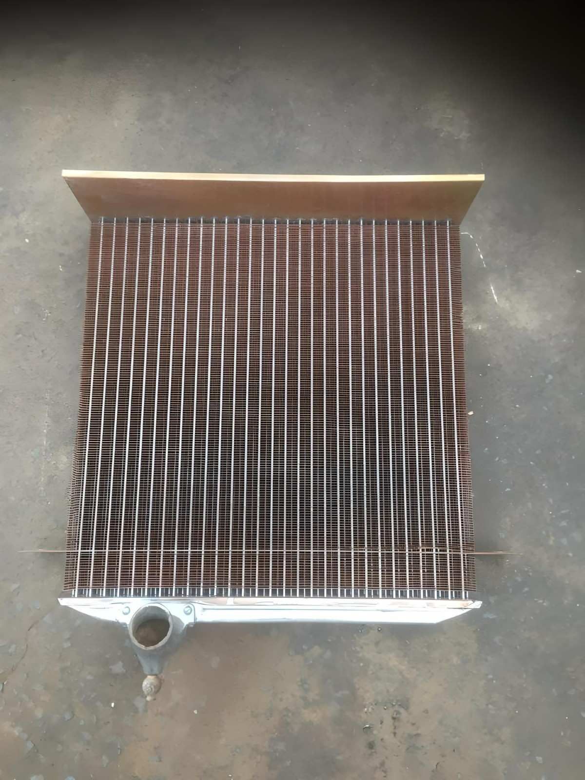 A Metal Radiator is Sitting on a Concrete Surface — Neilsen's Radiator Service in Toowoomba City, QLD